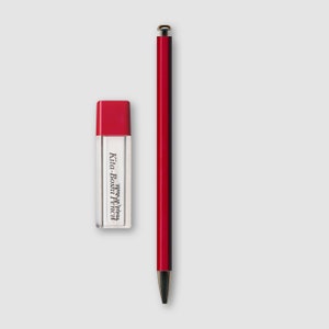May include: A red pen and eraser set. The pen is long and slender with a silver tip and cap. The eraser is rectangular with a red top and the text "Kita-Boshi Pencil" printed on the side.