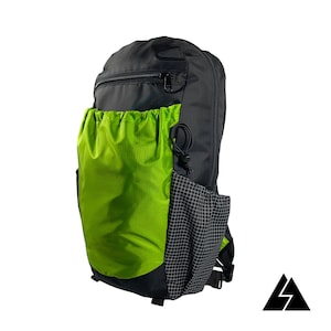May include: A black and green backpack with a drawstring top and a mesh pocket on the side.
