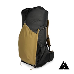 May include: A black and tan backpack with a grid pattern. The backpack has a large main compartment, a tan side pocket, and a black mesh side pocket. The backpack has adjustable straps and a logo in the bottom right corner.