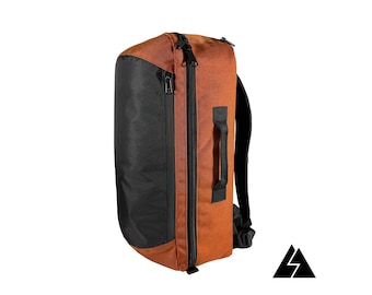 May include: A brown and black travel backpack with a zipped front pocket and a handle on the side.