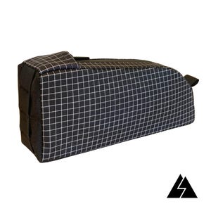 May include: Black and white grid patterned bike handlebar bag with a zipper closure and a black strap.