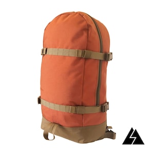 May include: A bright orange backpack with brown straps and buckles. The backpack has a zipped closure and a small loop on the bottom.