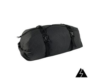 May include: Black, rectangular, waterproof dry bag with a grid pattern and adjustable straps with buckles.