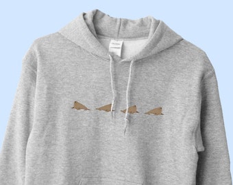 May include: A grey hooded sweatshirt with a graphic of four brown seals in a line on the front. The sweatshirt has a kangaroo pocket and long sleeves.