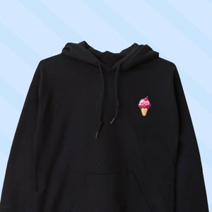 Op de afbeelding: Zwart hoodie met een klein ijsje-print op de linker borst.