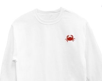 May include: White long-sleeved sweatshirt with a red crab embroidered on the left chest.