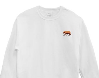 May include: White sweatshirt with a brown bear embroidered on the left chest.