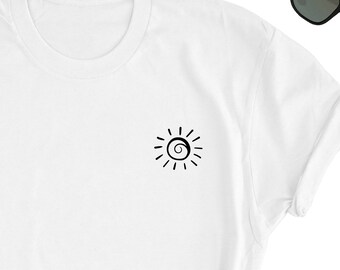 May include: White t-shirt with a black sun graphic on the front. The sun has a spiral in the center.