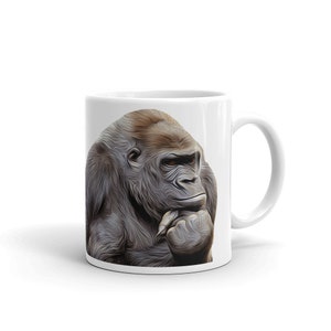May include: White ceramic mug with a full-color image of a gorilla thinking, with its chin resting on its hand.