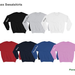 May include: Unisex sweatshirts in a variety of colors, including black, sport gray, white, red, navy, royal blue, and pink. The sweatshirts are all plain and feature the color name printed on the sleeve.