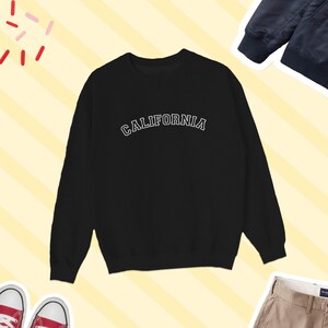 May include: Black sweatshirt with white text that reads "CALIFORNIA" in an arched font.