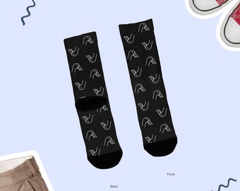 May include: A pair of black socks with a white duck pattern. The socks are shown from the front and back. The text "Front" and "Back" are written below the socks.