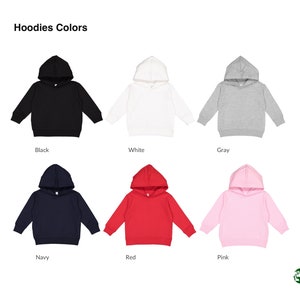 May include: Hoodies in six different colors: black, white, gray, navy, red, and pink. The hoodies are all the same style, with a drawstring hood and a kangaroo pocket.