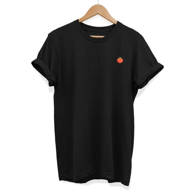 May include: A black t-shirt with a small red tomato graphic on the front.