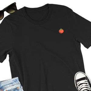 May include: A black short-sleeved t-shirt with a small red tomato embroidered on the front.