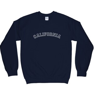 May include: A navy blue sweatshirt with the word "CALIFORNIA" printed in white on the front.