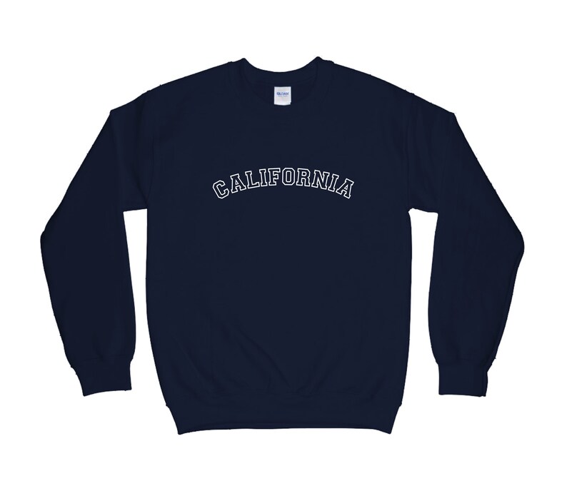 May include: A navy blue sweatshirt with the word "CALIFORNIA" printed in white on the front.
