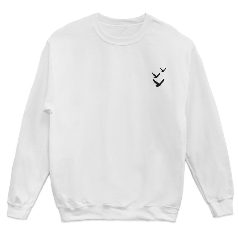 May include: White long-sleeved sweatshirt with a small black silhouette of three birds flying in formation on the left chest.