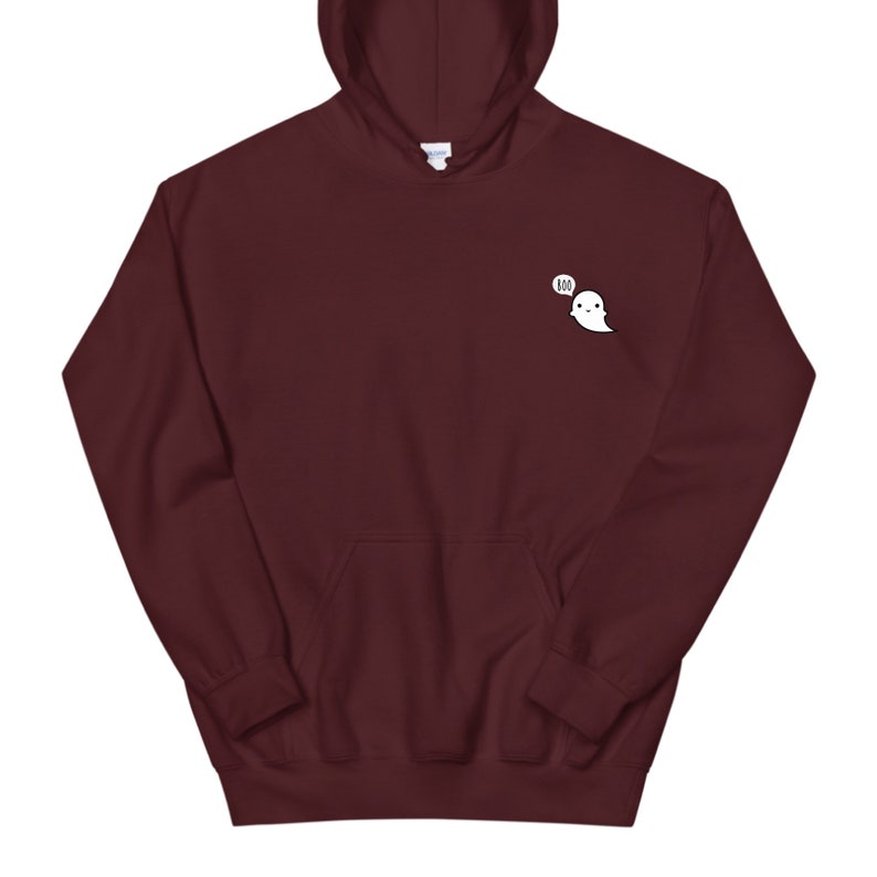 May include: A maroon hoodie with a front pocket and hood. A small white ghost graphic with the word "BOO" in a speech bubble is on the upper left chest area. The hoodie is made of a soft material.