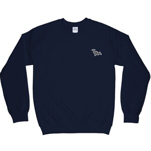 May include: A navy blue sweatshirt with a small, gray bat graphic on the left chest.