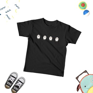 May include: Black short-sleeved t-shirt with a graphic of four white sheep in a row.