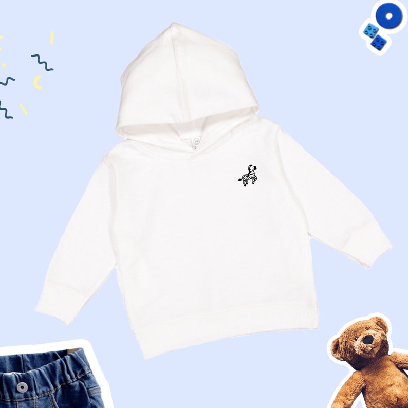 May include: White hooded sweatshirt with a small black and white zebra graphic on the front.