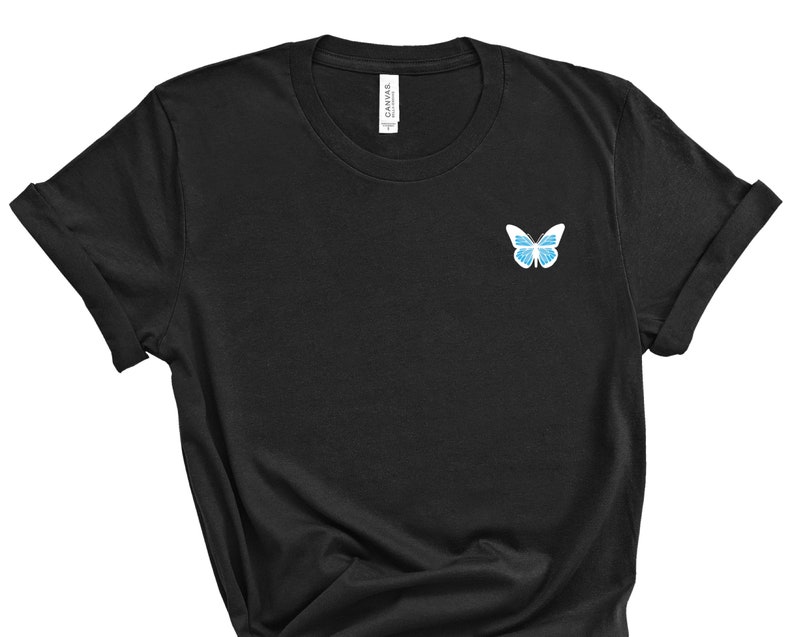 May include: Black t-shirt with a blue butterfly graphic on the left chest.