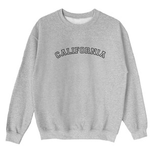 May include: A gray sweatshirt with the word "CALIFORNIA" printed in black on the front.