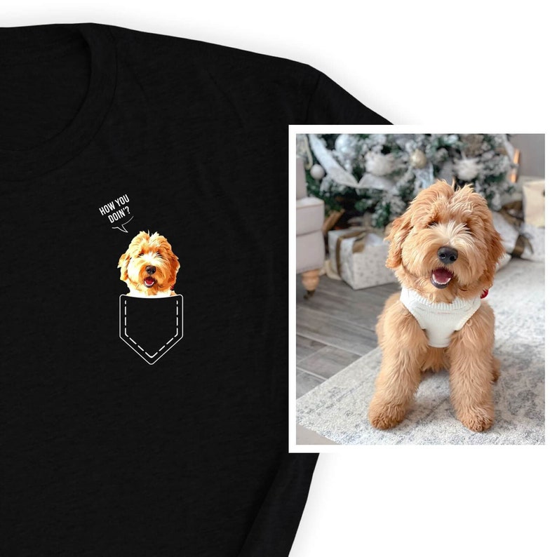 May include: Black t-shirt featuring a cartoon dog in a pocket with the text "HOW YOU DOIN'?" The dog is a light brown color. The image also shows a light brown dog wearing a white sweater.