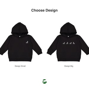 May include: Two black hooded sweatshirts with a zebra design. The sweatshirt on the left has a small zebra design on the front. The sweatshirt on the right has a larger zebra design with multiple zebras on the front. The text "Choose Design" is at the top of the image. The text "Design Small" is below the left sweatshirt. The text "Design Big" is below the right sweatshirt.