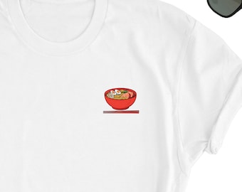 May include: White t-shirt with a red bowl of ramen noodles and chopsticks printed on the front.