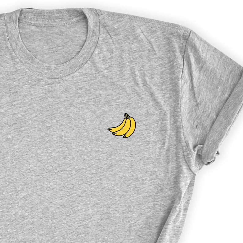May include: A gray t-shirt with a small embroidered image of three yellow bananas.
