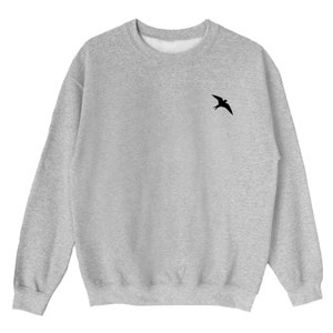 May include: A gray sweatshirt with a small black silhouette of a bird on the left chest.