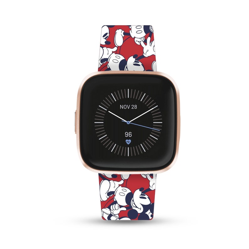 May include: A rose gold Fitbit Versa 3 smartwatch with a red and white Mickey Mouse print silicone band. The watch face displays the date "NOV 28" and the time. The heart rate is displayed as "96".