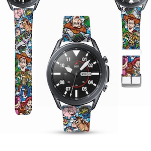 May include: A black smartwatch with a colorful Toy Story themed watch band. The watch face displays the time, date, and battery percentage. The band features characters like Woody, Buzz Lightyear, and Jessie.