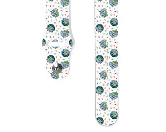 May include: White watch band featuring a repeating pattern of a green alien character in a blue and white circular design. The band also has small colorful lights. The watch band is made of a flexible material and has a silver clasp.