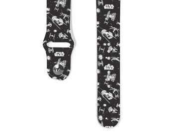 May include: Black and white Apple Watch band with a Star Wars theme. The band features a repeating pattern of X-Wings and TIE fighters against a black background. The text "Star Wars" appears multiple times on the band.