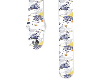 May include: White watch band featuring a repeating pattern of spaceships, planets, and explosions. The design includes the text "STAR WARS" and images of the Millennium Falcon and X-wing fighters. The band has a silver clasp.