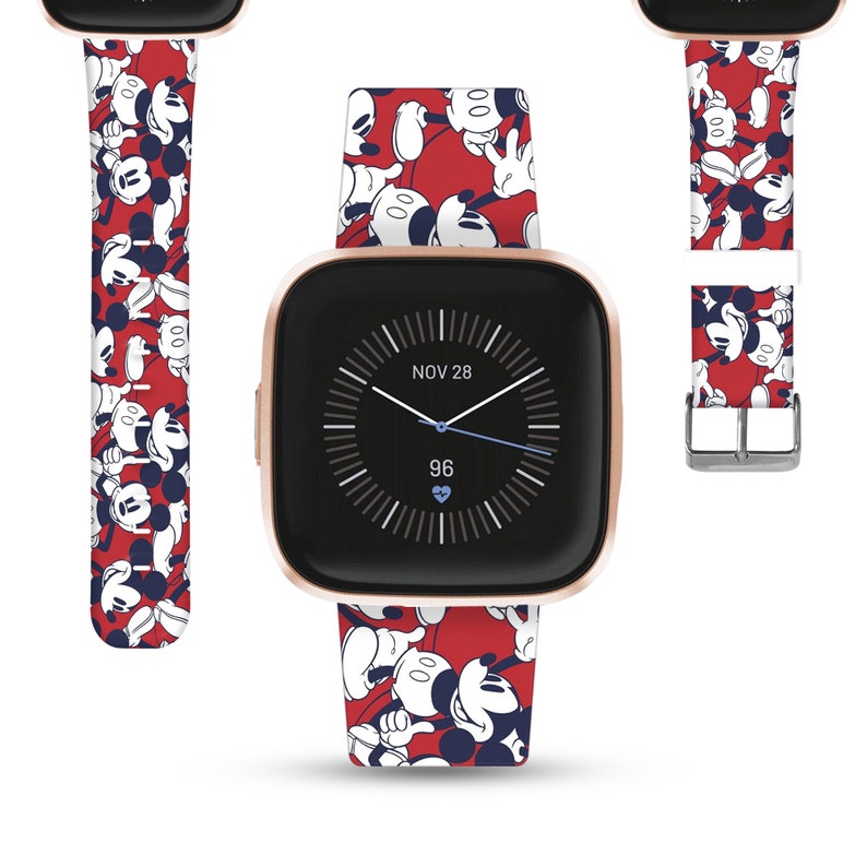 May include: A red, white, and blue Mickey Mouse watch band with a gold-colored watch face. The watch face displays the date "NOV 28" and the time "96".