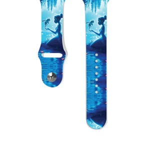 May include: A blue and white Apple Watch band featuring a silhouette of Tiana and a frog from the Disney film The Princess and the Frog.
