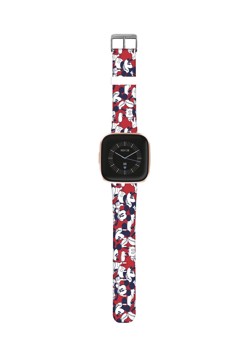 May include: Red silicone watch band with a white and blue Mickey Mouse print. The band is compatible with a square-shaped smartwatch with a rose gold colored frame. The watch face displays the date "NOV 28" and the time "96".