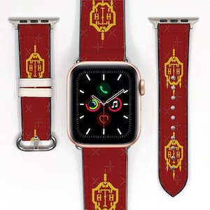 May include: A red Apple Watch band with a gold and white design featuring the text "H.T.H." The band is shown with a black Apple Watch face.