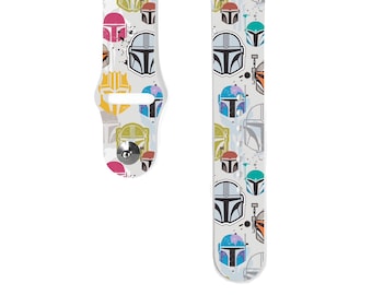 May include: White watch band featuring a repeating pattern of Mandalorian helmets in various colors. The helmets are in shades of red, blue, green, yellow, and orange. The band has a silver clasp.