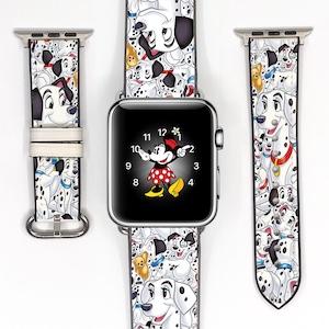 May include: A silver Apple Watch with a Minnie Mouse watch face and a white watch band featuring a Dalmatian pattern. The watch band is shown in three pieces, with a white background.