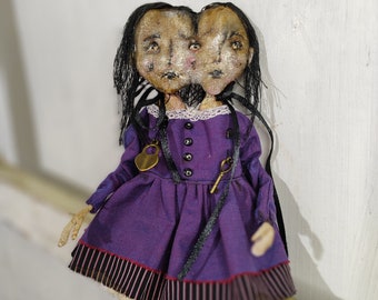 Siamese twins doll. A rare handmade toy. Conjoined twins with two heads and one body.