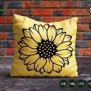 May include: A yellow pillow with a black silhouette of a sunflower. The sunflower has a large, round center with black and white dots.
