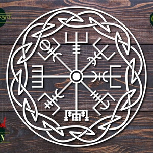 May include: A white, circular design with a compass rose in the center and a Celtic knot border. The compass rose features eight points with various symbols, including a cross, a triangle, and a circle. The design is on a wooden background.