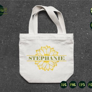 May include: A white tote bag with a sunflower design and the name "STEPHANIE" printed in green on a gold banner.