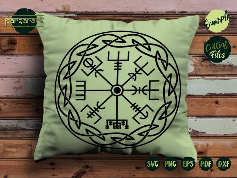 May include: A green throw pillow with a black and white compass design. The compass is surrounded by a circular knot pattern.