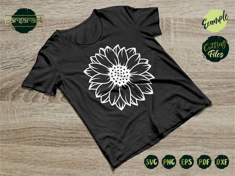 May include: A black t-shirt with a white outline of a sunflower on the front. The shirt is on a wooden surface. The text "Example Cutting Files" is in the upper right corner of the image. The text "SVG PNG EPS PDF DXF" is in the lower right corner of the image.